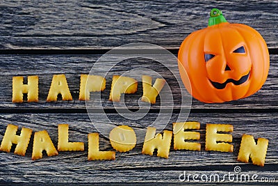 Happy Halloween words decoration with jack lantern pumpkin on wooden background Stock Photo