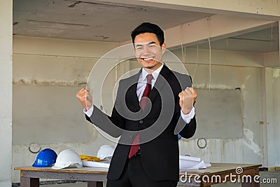 Happy handsome businessman acting hooray Stock Photo