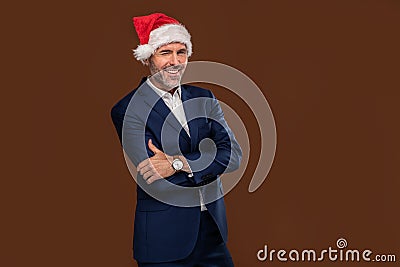 Happy handsome businessman wearing santa claus cap winks to the camera Stock Photo