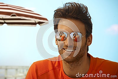 Happy handsome casual man wearing mirror shades Stock Photo