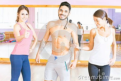 Happy handsome man with group peolpe in fitness class Stock Photo