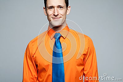 Happy handsome man in orange shirt. Stock Photo