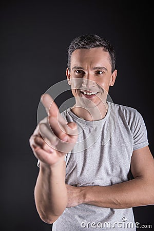 Happy handsome man touching sensory screen Stock Photo