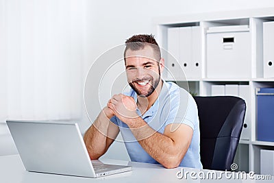 Happy handsome young business man working Stock Photo