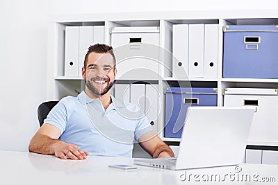 Happy handsome young business man working Stock Photo