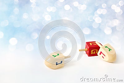 Happy Hanukkah greeting card, invitation Traditional Jewish Festival of lights holiday symbols. Wooden dreidel toys on Stock Photo