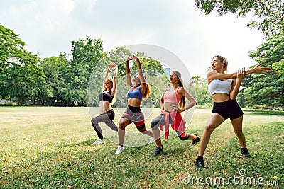 Happy healthy four beautiful young teenagers woman training and stretching for warming up before exercise in the park. fitness, Stock Photo