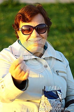 Happy healthy old woman eating sun flower seeds Stock Photo