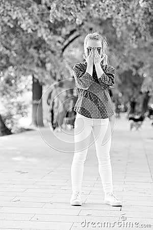 Happy hiding game outdoors. Hide and seek urban background. Happy childhood active games. Healthy emotional happy kid Stock Photo