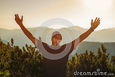 Happy hiker enjoying his travel, while he stands on the top of Stock Photo