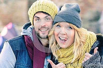 Happy hipster couple in love take a selfie photo during sunny day in autumn. Best friends with winter clothes sharing free time. Stock Photo