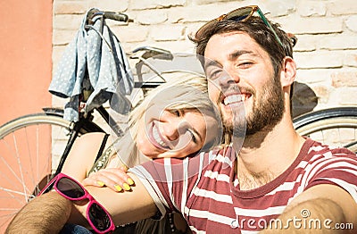 Happy hipster couple taking selfie at old town trip with bicycle Stock Photo