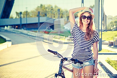 Happy Hipster Girl with Bike in the City Stock Photo