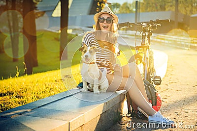Happy Hipster Girl with her Dog in the City Stock Photo