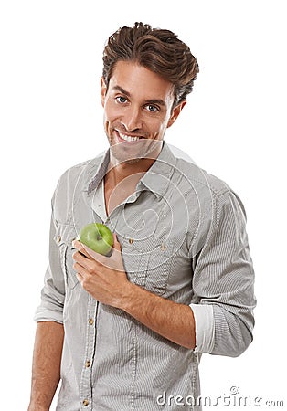 Happy with his diet. Portrait of a handsome young man holding an apple and smiing. Stock Photo