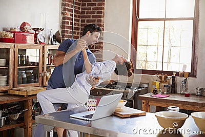 Happy Hispanic couple dancing in kitchen in the morning Stock Photo