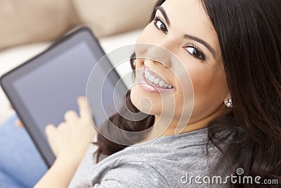 Happy Hispanic Woman Using Tablet Computer or iPad Stock Photo