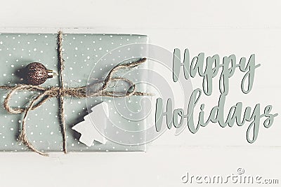 Happy holidays text, seasonal greetings card sign. modern christ Stock Photo