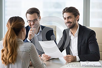 Happy hr manager with resume looking at female job seeker. Stock Photo