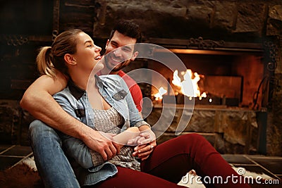 Happy hugging couple enjoying in mountain house Stock Photo