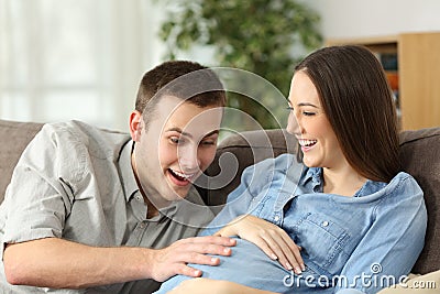 Happy husband and pregnant woman expecting birth Stock Photo