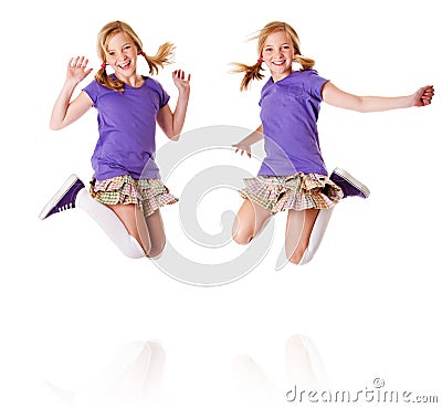 Happy identical twins jumping and laughing Stock Photo