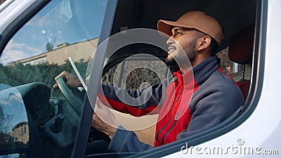 Happy indian courier using tablet in the van Stock Photo