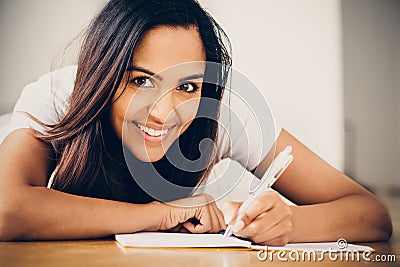 Happy Indian woman student education writing studying Stock Photo