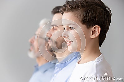 Child boy grandson stand in row with father and grandfather Stock Photo