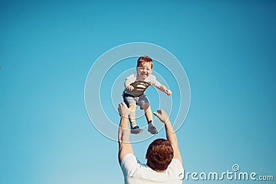 Happy joyful child, father fun throws up son in the air, summer Stock Photo