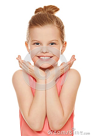 Happy joyful little girl smiling with hands near face, isolated on white background Stock Photo