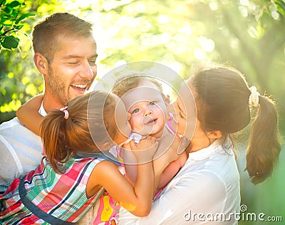 Happy joyful young family having fun outdoors Stock Photo