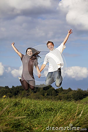 Happy jumping teenage couple Stock Photo