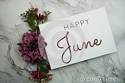 Happy June text with pink flower bouquet on marble background Stock Photo