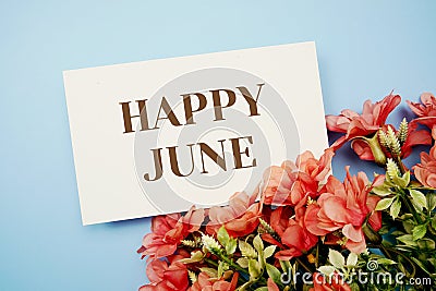 Happy June text with flower frame on blue background Stock Photo