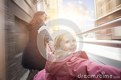 Happy kid laughing with mother outdoor, motion Stock Photo