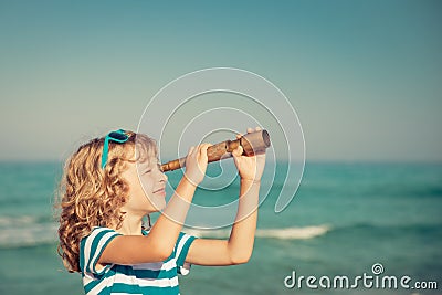 Happy kid playing outdoor against sea and sky Stock Photo