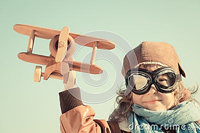 Happy kid playing with toy airplane Stock Photo