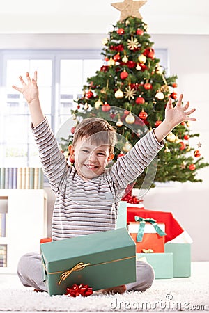 Happy kid raising arms at christmas Stock Photo