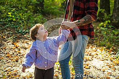 Happy kids autumn. We like autumn time together. Parent teach baby. Happy family, father and baby son playing and Stock Photo