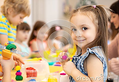 Happy kids doing arts and crafts in day care centre Stock Photo