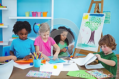 Happy kids doing arts and crafts together Stock Photo