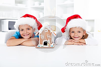 Happy kids with gingerbread house at christmas Stock Photo