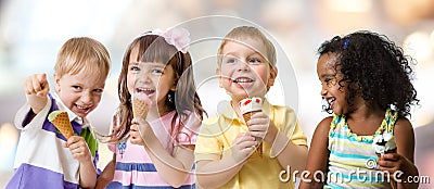 Happy kids group eating ice cream at a party in cafe Stock Photo