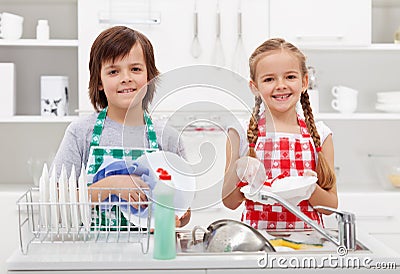 Happy kids helping in the kitchen Stock Photo