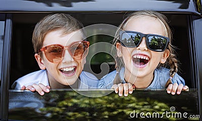 Happy kids looking out the car window Stock Photo