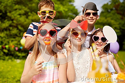Happy kids with party props on birthday in summer Stock Photo