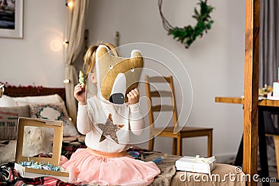 Kids playing in bedroom. Little girl play on the bed. Stock Photo