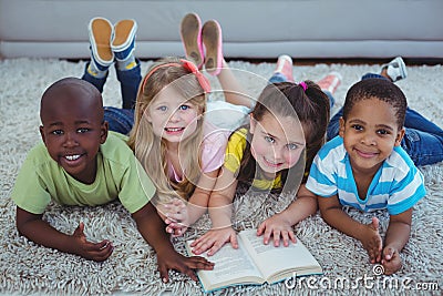 Happy kids reading a book together Stock Photo