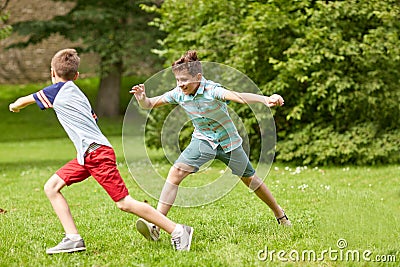 Happy kids running and playing game outdoors Stock Photo